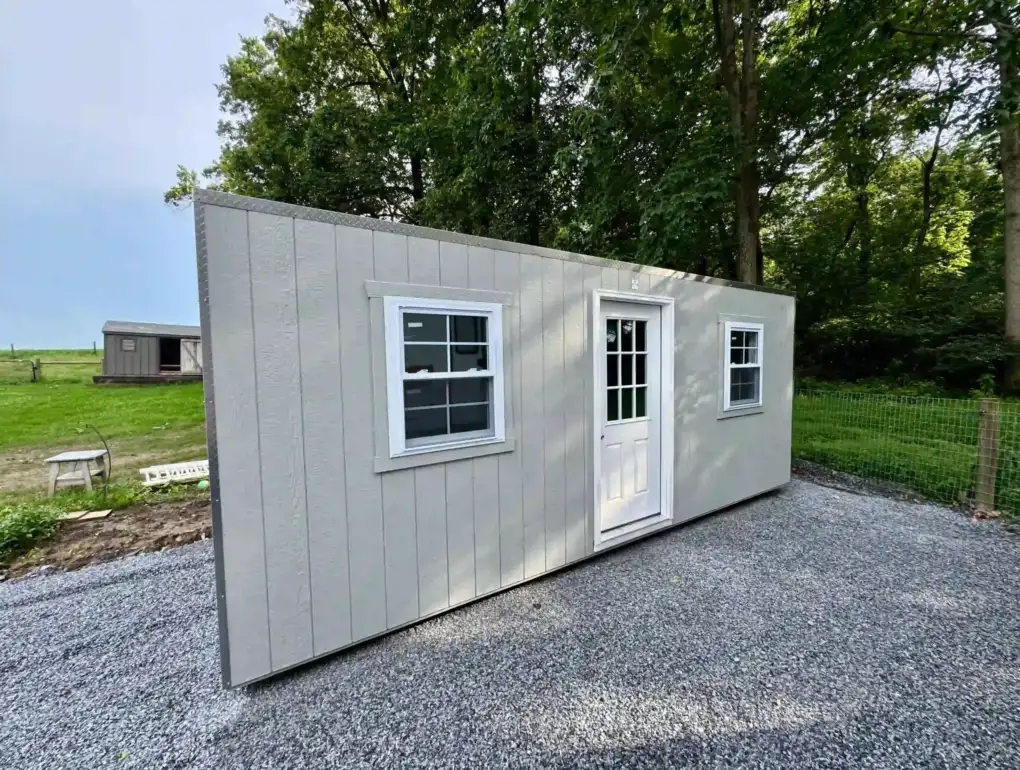 A modern portable office shed with a glass-paned door and windows, installed on a new gravel pad in Pennsylvania by Mill Run Storage.