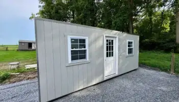 A modern portable office shed with a glass-paned door and windows, installed on a new gravel pad in Pennsylvania by Mill Run Storage.