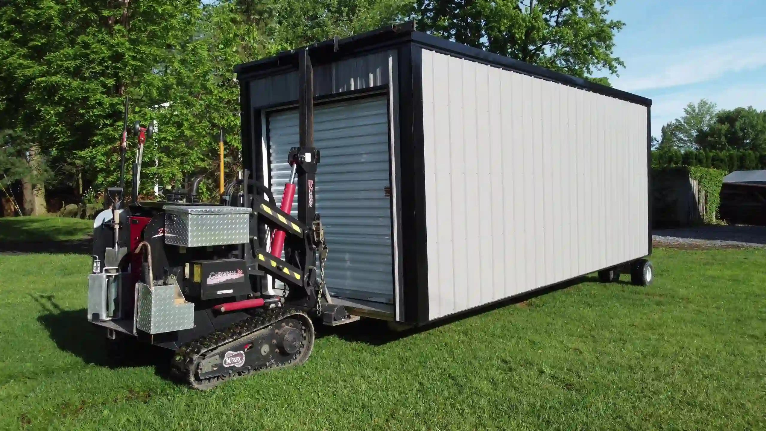 A close-up of our tracked shed mover, the key to our tight-access and yard-safe delivery service.