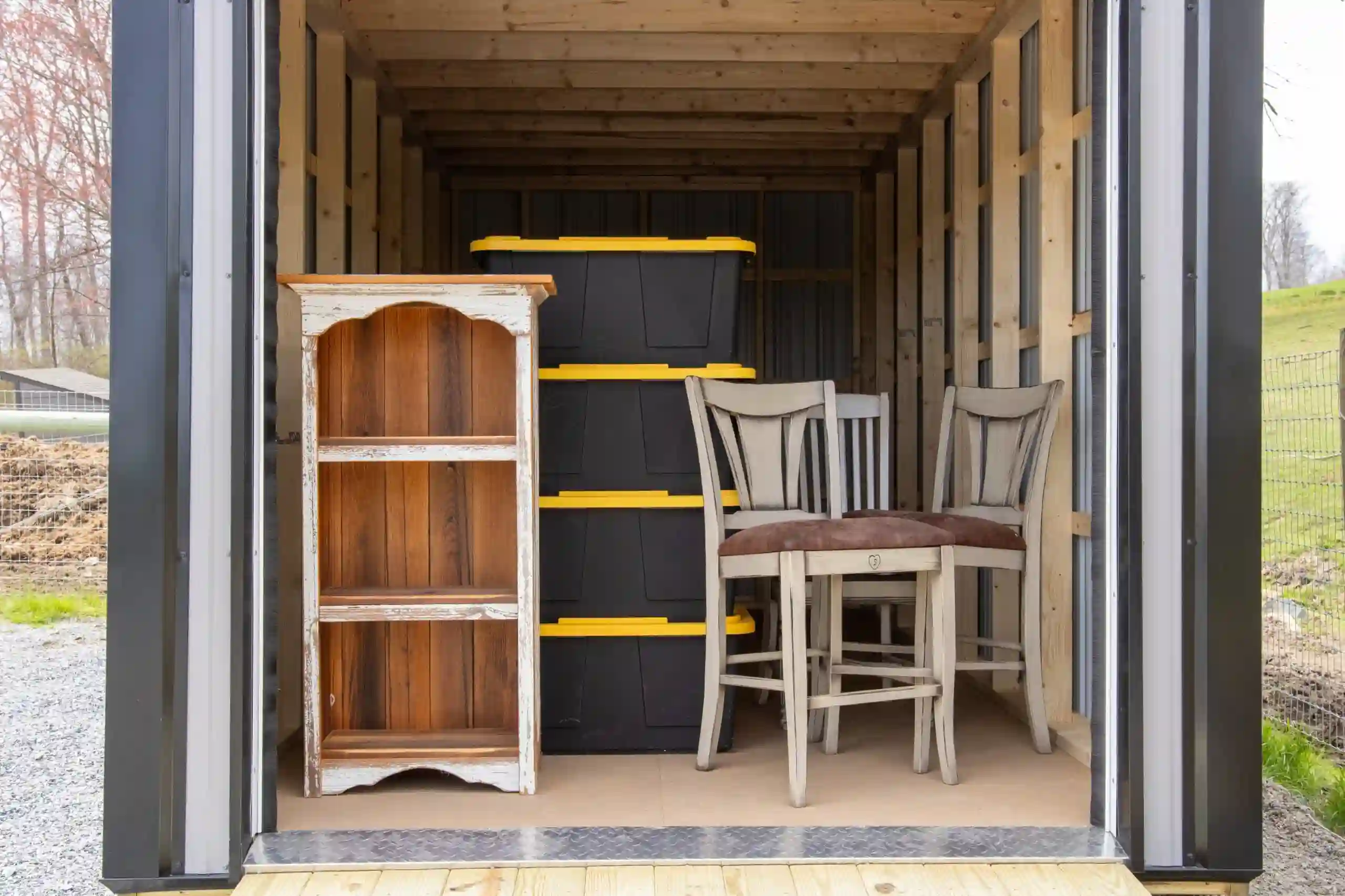 A look inside a Mill Run Storage unit showing how easily it fits both furniture and stacked storage boxes.