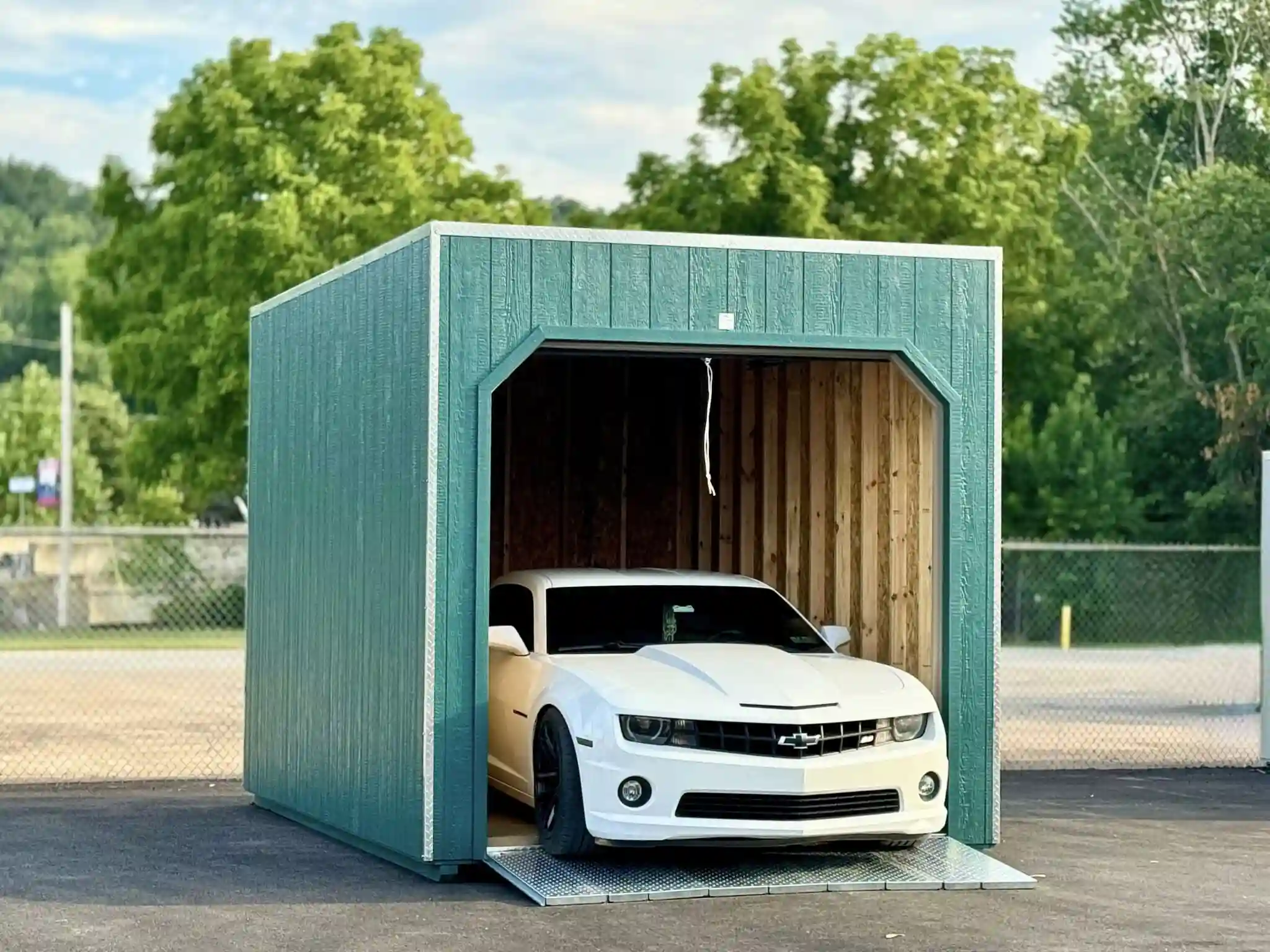 A portable single-car garage from Mill Run Storage providing a secure, weatherproof home for a classic Chevrolet Camaro.