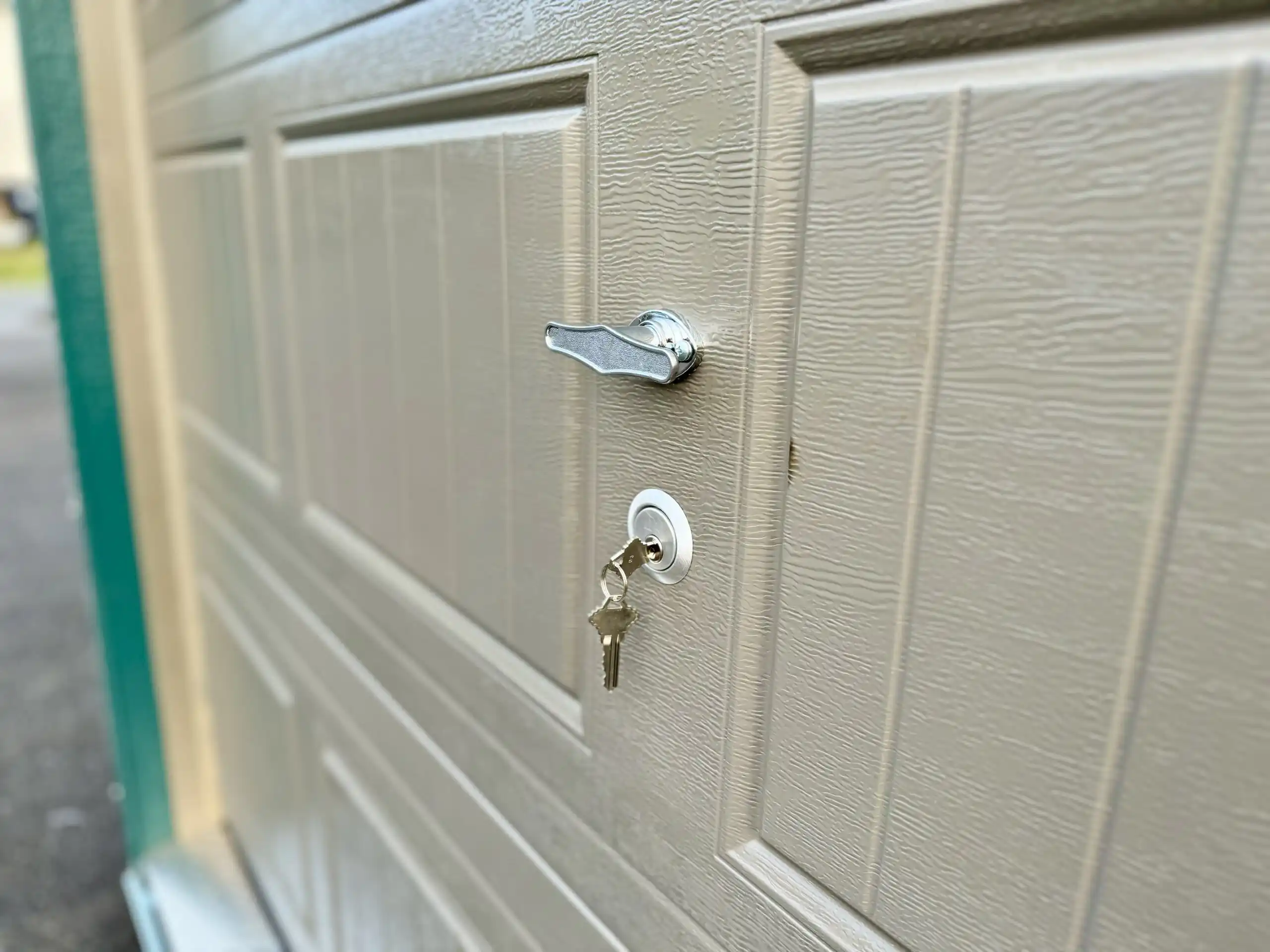 A close-up of the secure T-handle and key lock system on our portable garage doors.