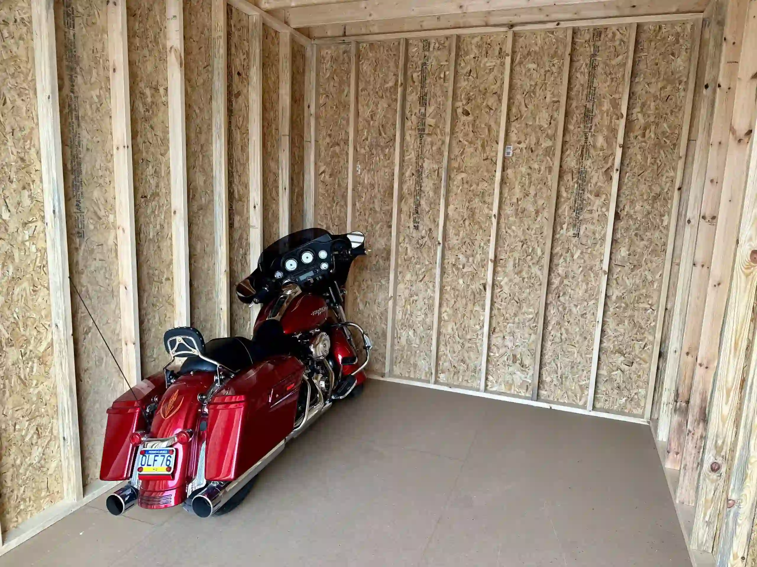 A secure, spacious portable garage providing year-round protection for a Harley-Davidson motorcycle.