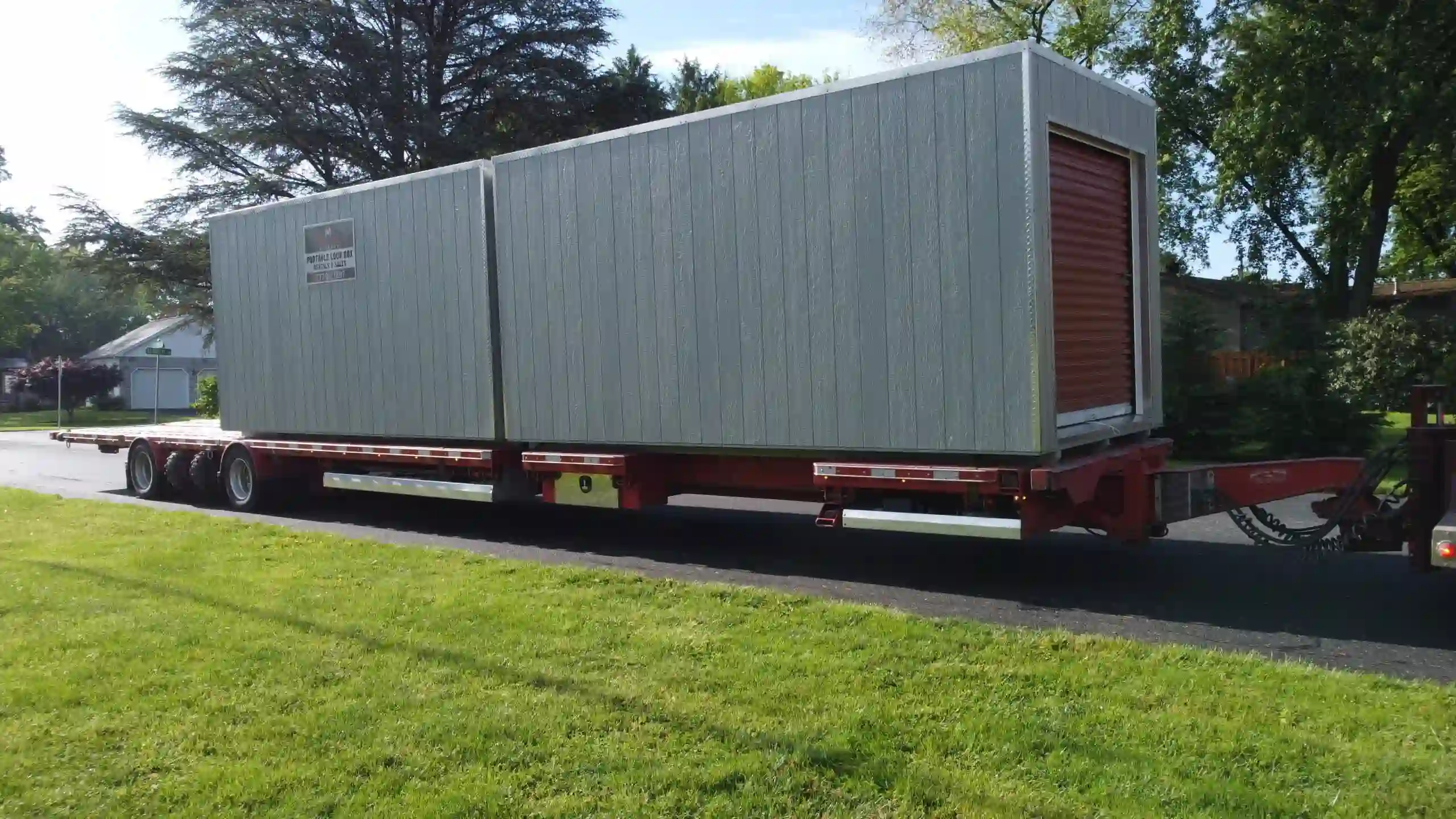 A semi-truck from Mill Run Storage transporting multiple Portable Lock Box units for a large residential or commercial job.