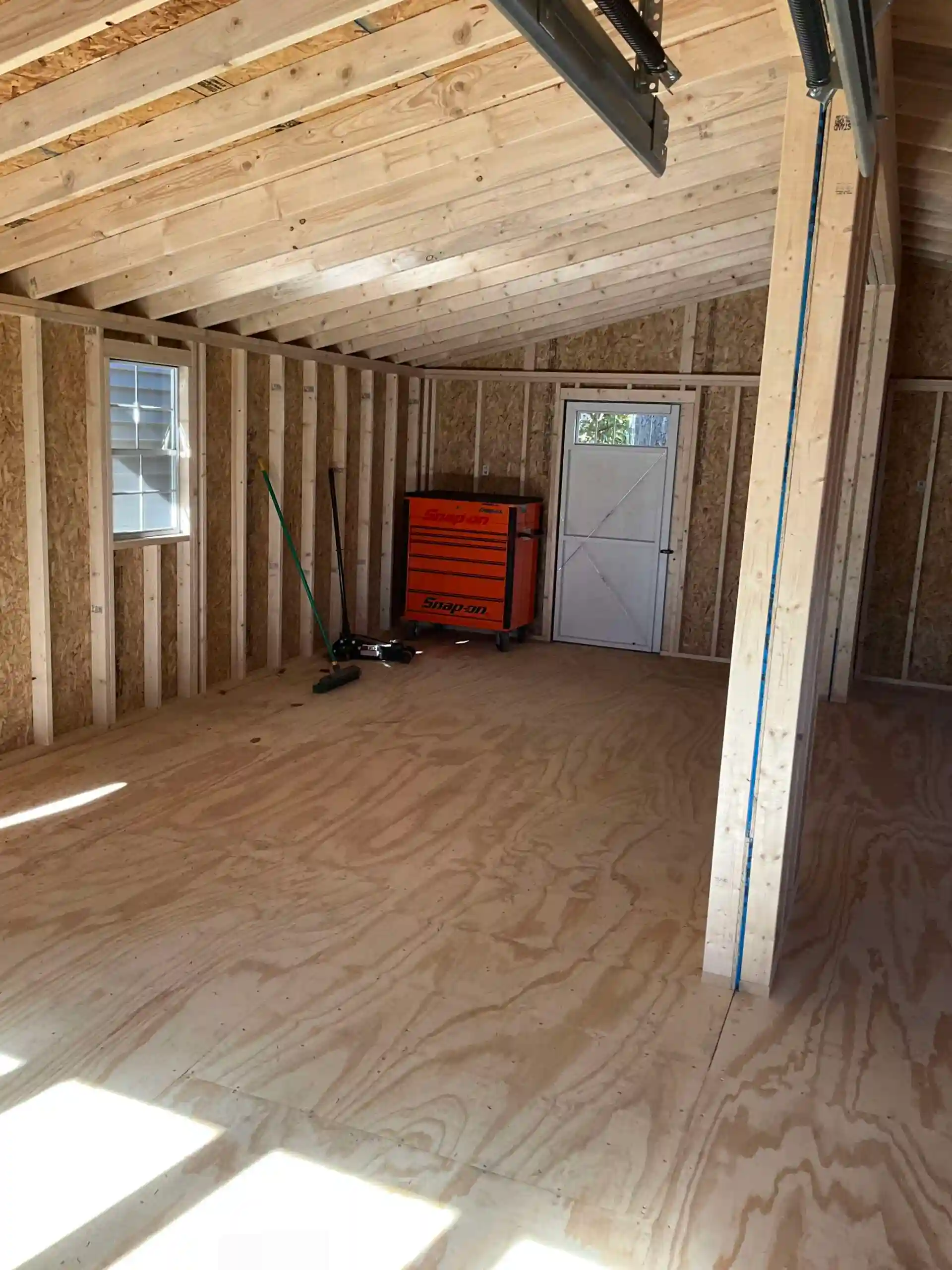 A view of the sturdy interior construction of a Mill Run Storage garage, with plenty of room for tool chests and workshop equipment.