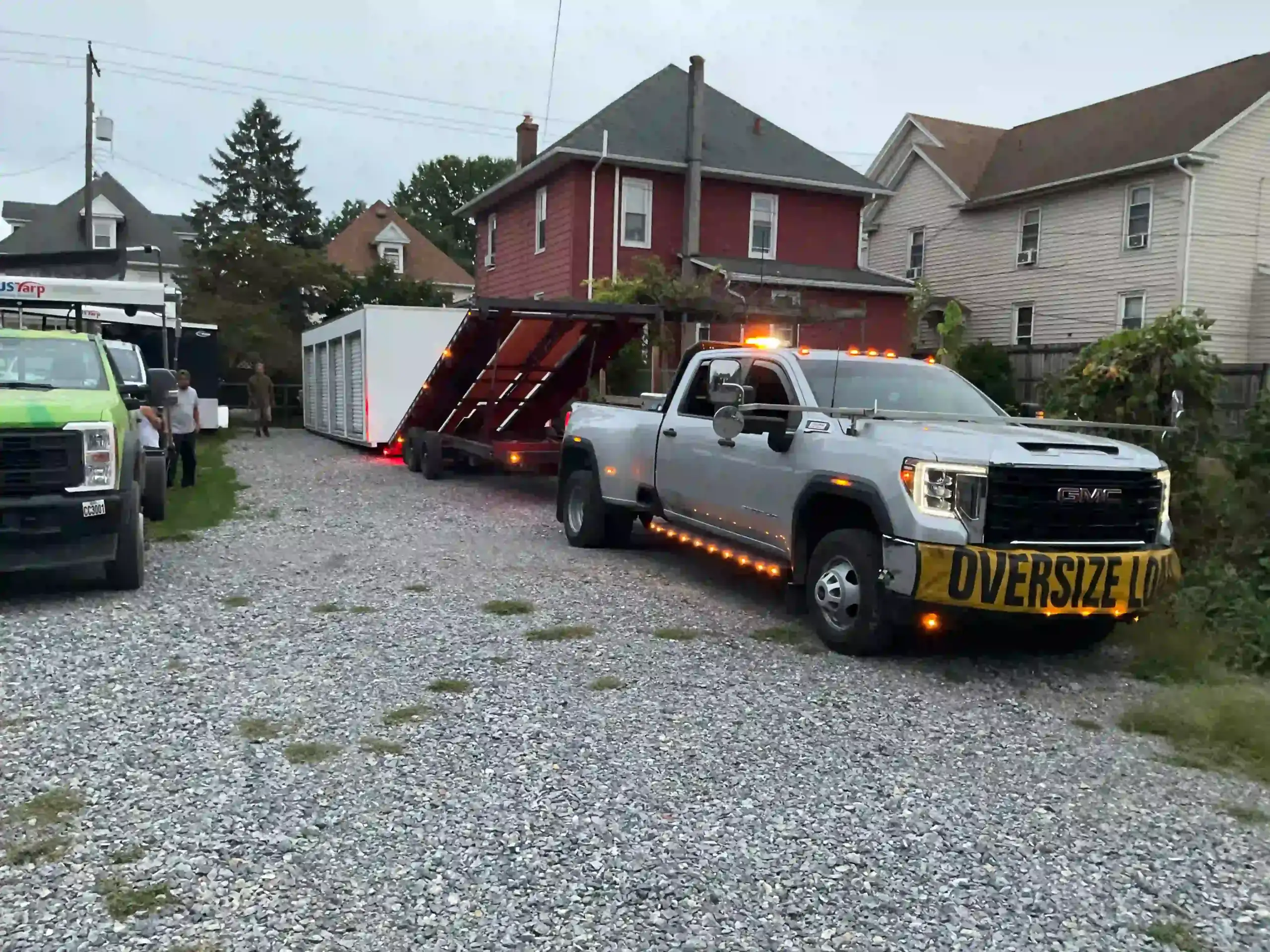 Carefully maneuvering a large storage building into a tight residential space in Manheim with our specialized delivery equipment.
