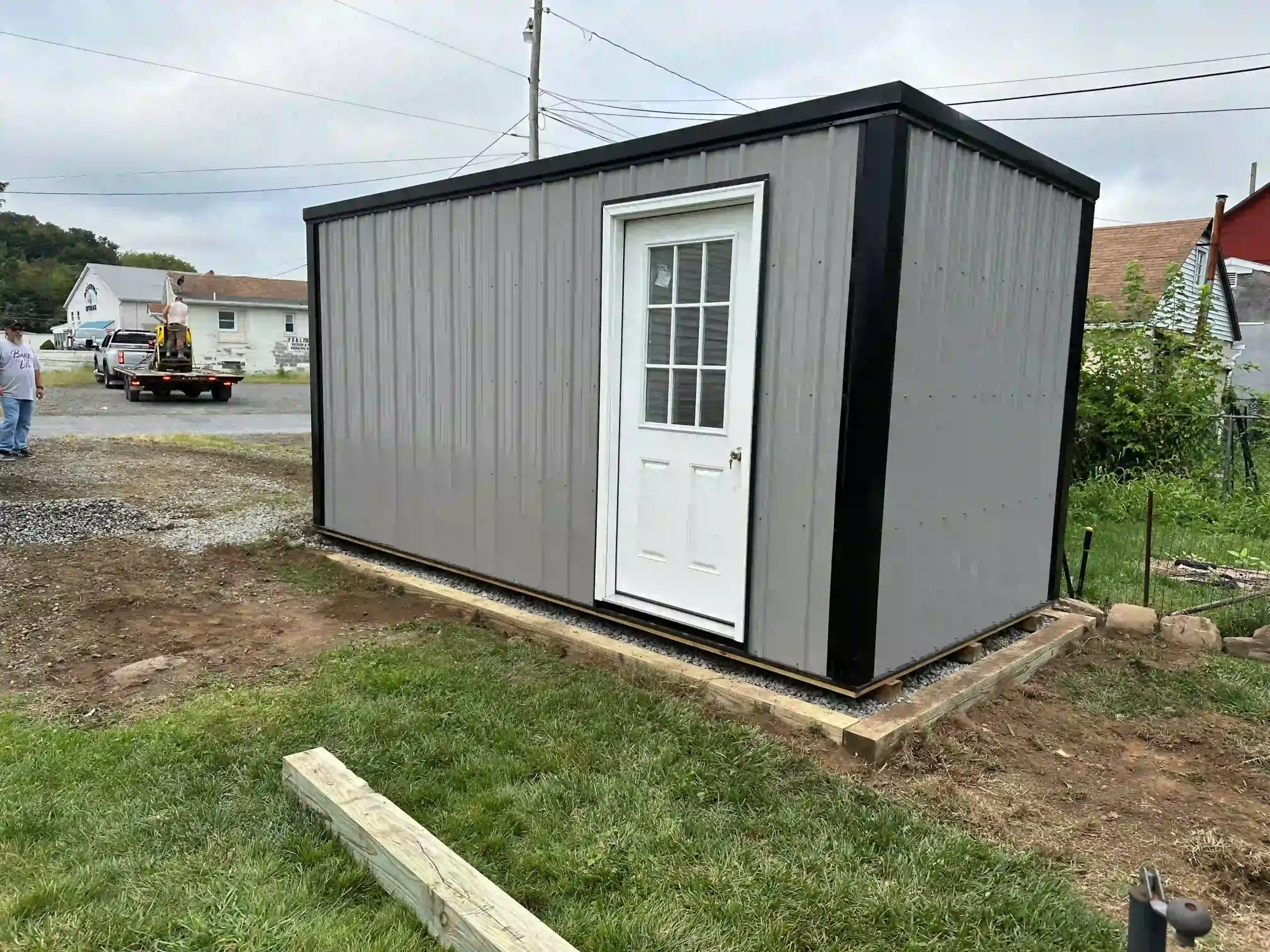 A finished metal portable office installed perfectly on a new foundation, demonstrating our complete site prep and installation services.
