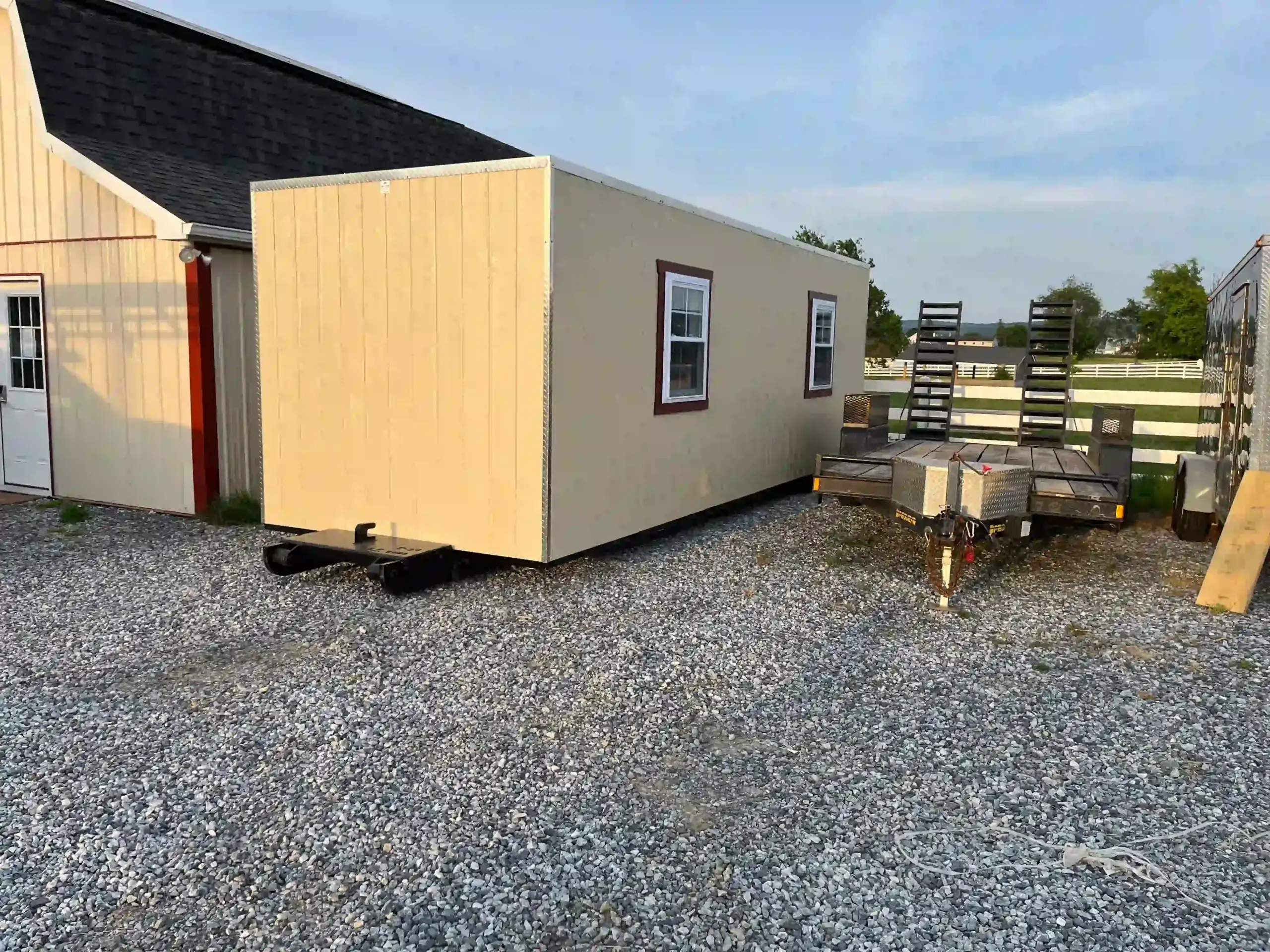 Using a remote-controlled 'shed mule' to precisely place a large portable building, allowing for placement without damaging the yard.