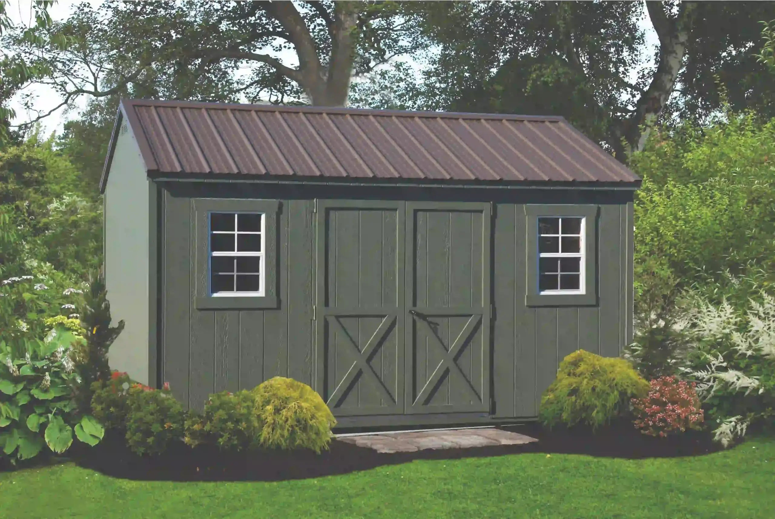 A durable, dark green storage shed featuring a heavy-duty metal roof and classic crossbuck doors, built to last by Mill Run Storage.