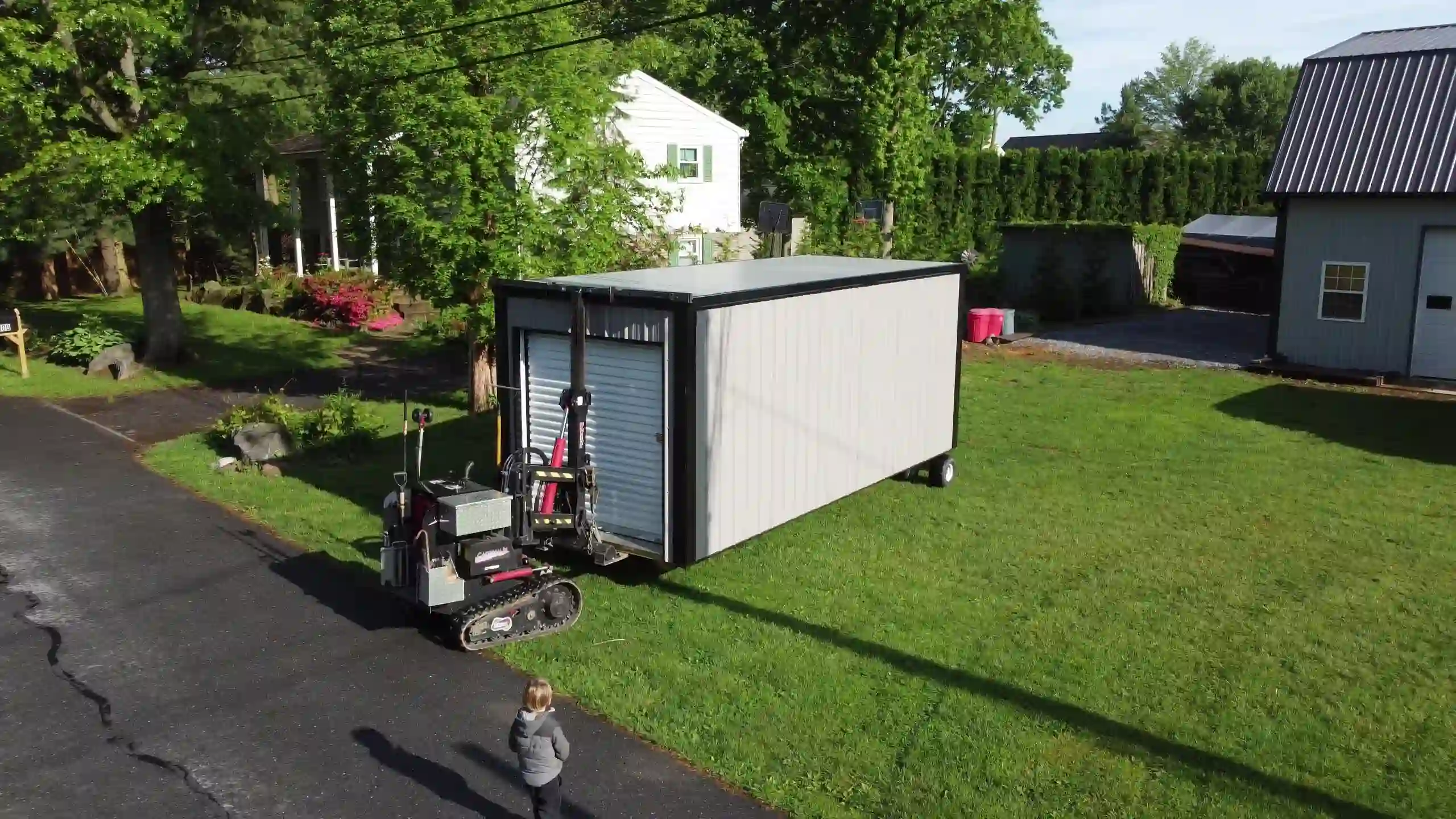 Our shed mover carefully navigating a residential street to deliver a portable storage unit with minimal disruption.