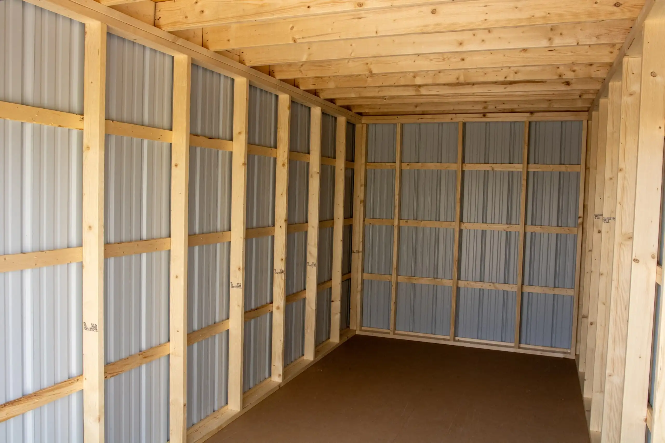 The clean, spacious, and sturdy interior of a portable storage container, showing the metal walls and wood frame construction.